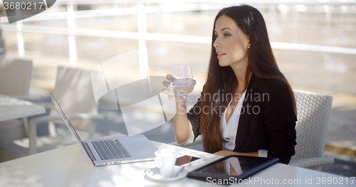 Image of Businesswoman enjoying coffee at a restaurant