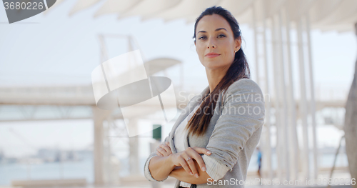 Image of Smiling stylish woman looking down at the camera