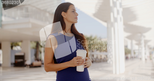 Image of Attractive woman holding a large cup of coffee