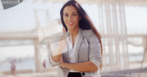 Image of Motivated young woman giving a thumbs up