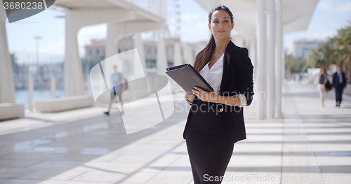 Image of Elegant businesswoman on a seafront promenade