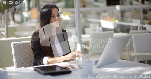 Image of Businesswoman working at an open-air table