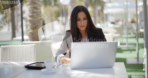Image of Businesswoman working at an open-air table