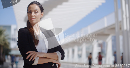 Image of Thoughtful businesswoman with folded arms