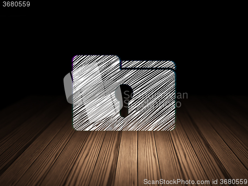 Image of Finance concept: Folder With Keyhole in grunge dark room