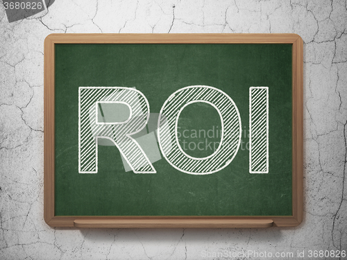 Image of Business concept: ROI on chalkboard background