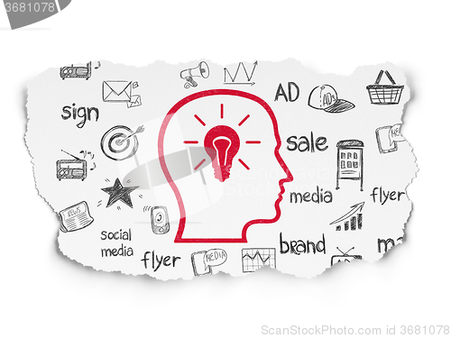 Image of Advertising concept: Head With Lightbulb on Torn Paper background