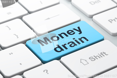 Image of Currency concept: Money Drain on computer keyboard background