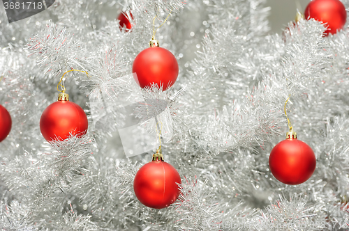 Image of Red baubles on silver artificial christmas tree