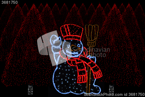 Image of Illuminated Snowman and christmas trees 