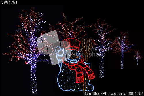 Image of Illuminated Snowman and trees 