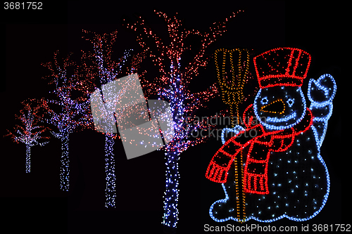 Image of Illuminated Snowman and trees 