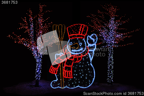 Image of Illuminated Snowman and trees 