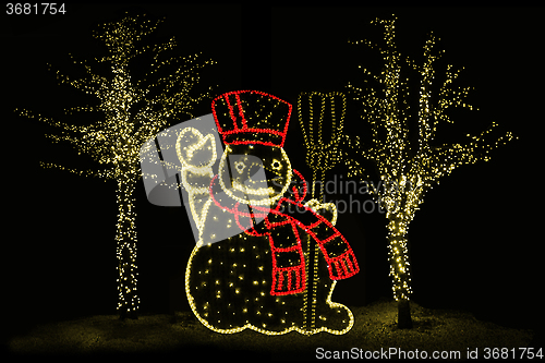 Image of Illuminated Snowman and trees 