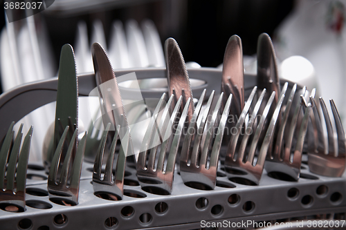 Image of Open dishwasher with clean utensils