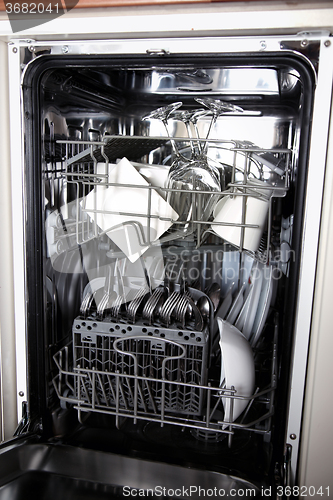 Image of Open dishwasher with clean utensils