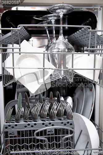 Image of Open dishwasher with clean utensils