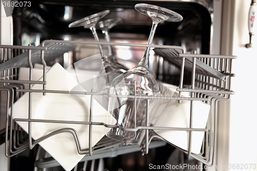 Image of Open dishwasher with clean utensils