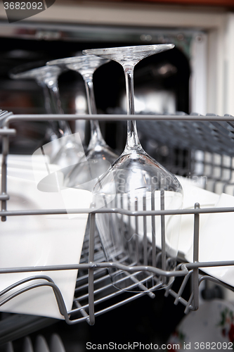 Image of Open dishwasher with clean utensils