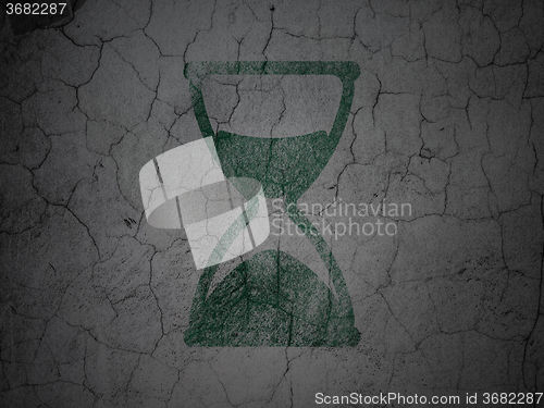 Image of Timeline concept: Hourglass on grunge wall background