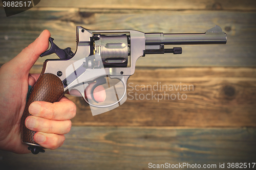 Image of revolver gun in a human hand