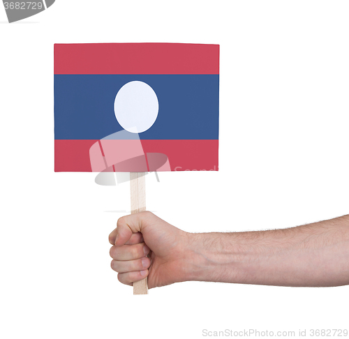 Image of Hand holding small card - Flag of Laos