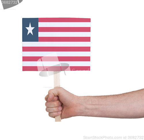 Image of Hand holding small card - Flag of Liberia