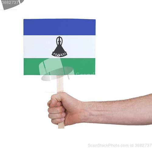 Image of Hand holding small card - Flag of Lesotho