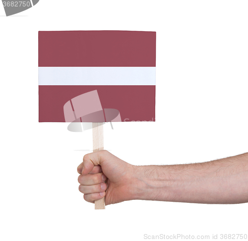 Image of Hand holding small card - Flag of Latvia