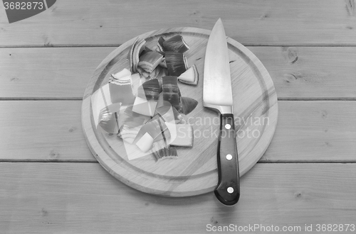 Image of Chopped red onion with a knife on a chopping board