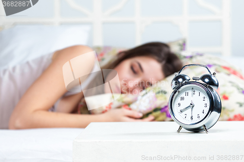 Image of The young girl sleeping in bed