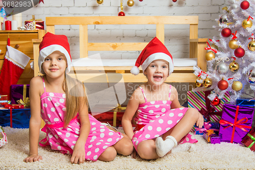 Image of Funny girl gnome sitting on a mat in a Christmas setting