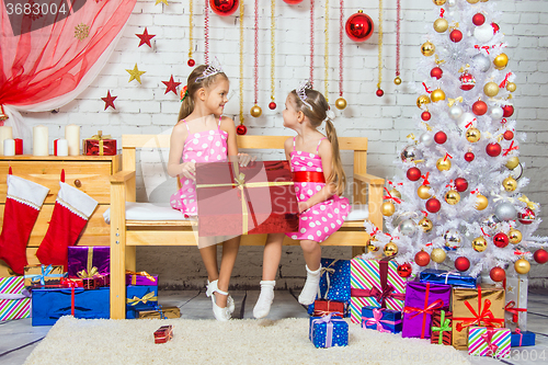 Image of Joyful girl who gave a great gift at each other in a Christmas setting