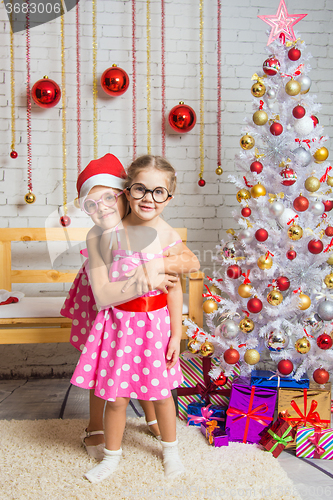 Image of The girl hugged the other girl in funny round glasses