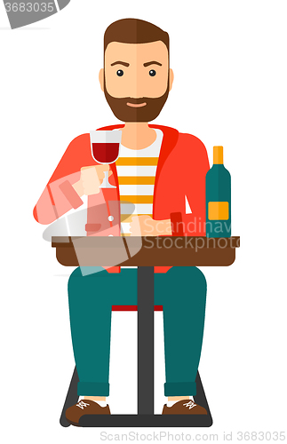 Image of Man sitting at bar.