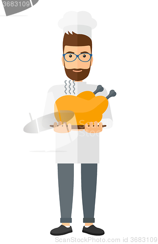 Image of Man holding roasted chicken.