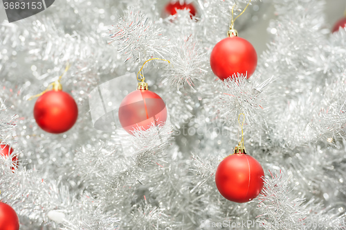 Image of Red baubles on silver artificial christmas tree