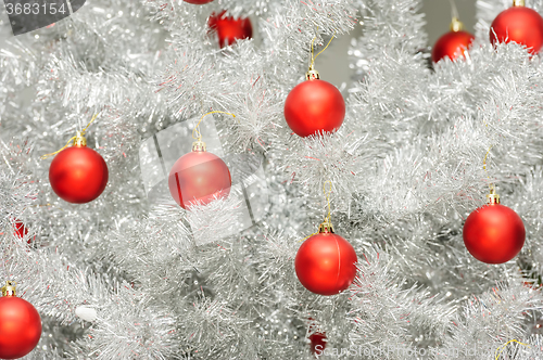 Image of Red baubles on silver artificial christmas tree