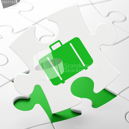 Image of Travel concept: Bag on puzzle background