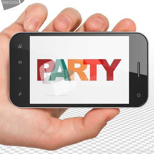 Image of Entertainment, concept: Hand Holding Smartphone with Party on  display