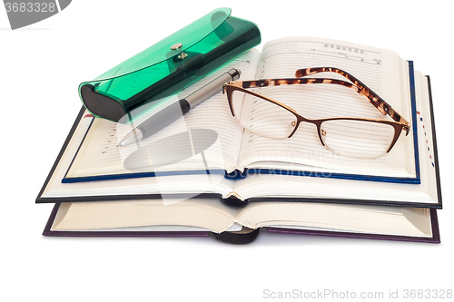 Image of Glasses, books and notebooks on white background.