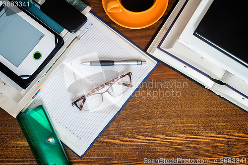 Image of Book, notebook, glasses on your desktop.