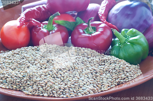 Image of Lentils ready to be cooked with tomatoes , peppers , eggplant