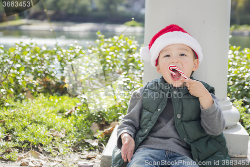 Image of Cute Mixed Race Boy With Santa Hat and Candy Cane