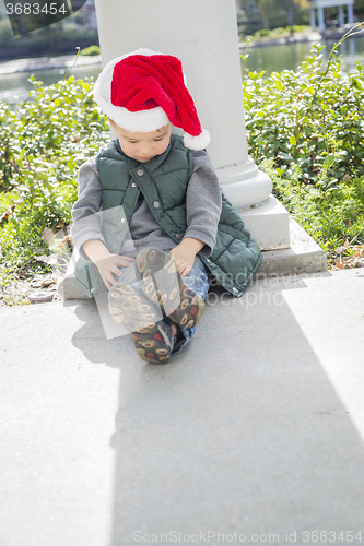 Image of Melancholy Mixed Race Boy Wearing Christmas Santa Hat