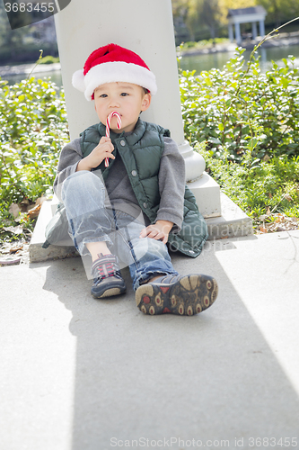 Image of Cute Mixed Race Boy With Santa Hat and Candy Cane