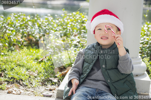 Image of Cute Mixed Race Boy With Santa Hat and Candy Cane