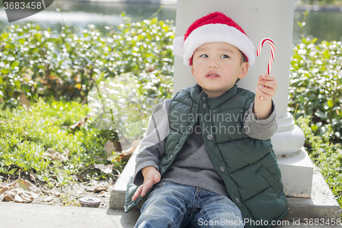 Image of Cute Mixed Race Boy With Santa Hat and Candy Cane