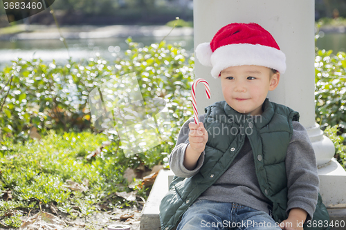 Image of Cute Mixed Race Boy With Santa Hat and Candy Cane