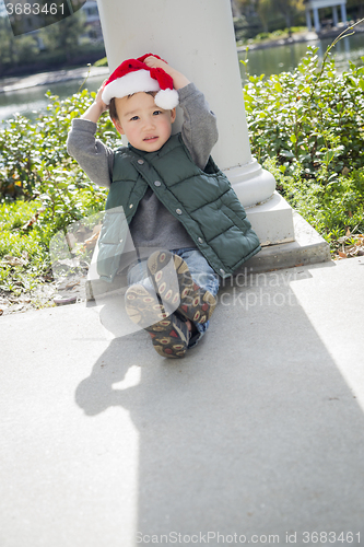 Image of Cute Mixed Race Boy Wearing Christmas Santa Hat